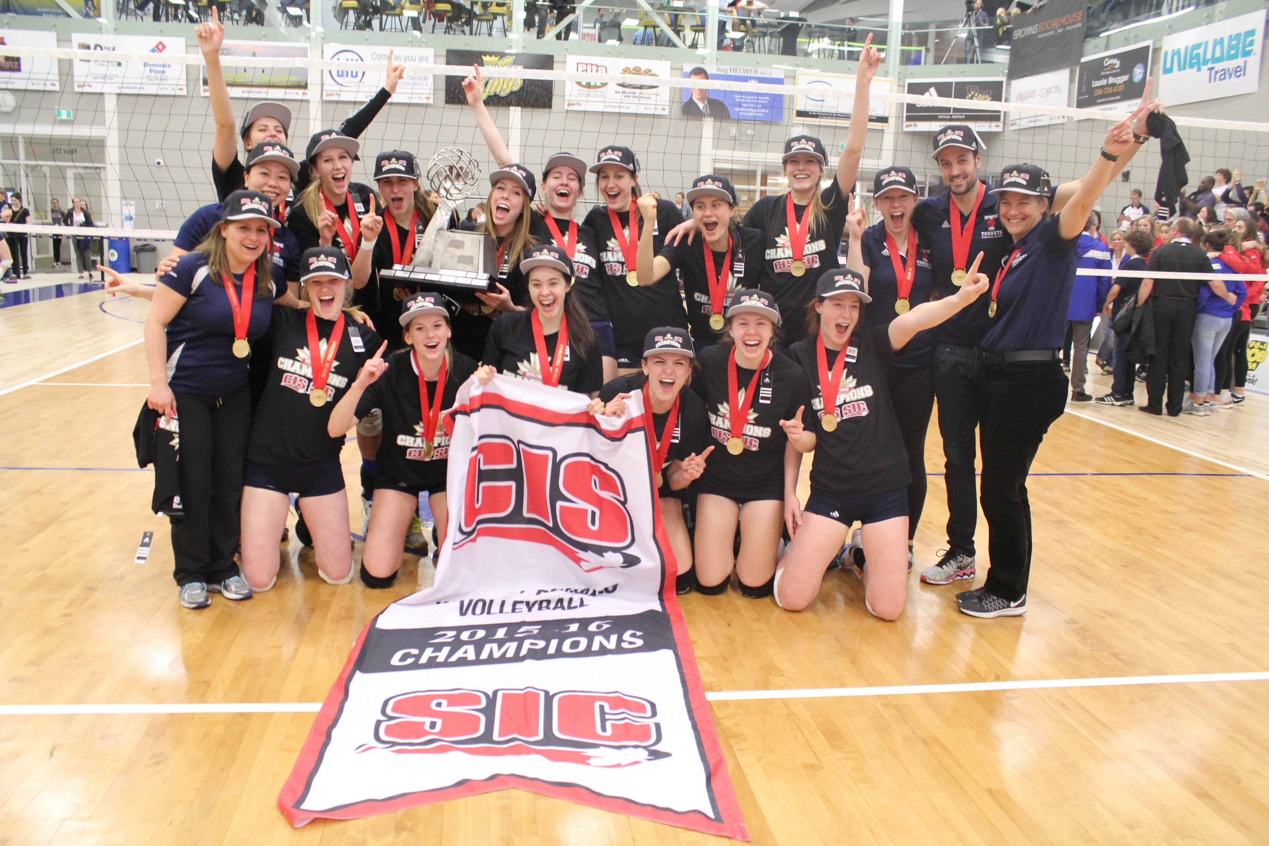 Women's Volleyball team with the CIS championship banner. MACKENZIE GERRY/CC THE UNIVERSITY OF TORONTO